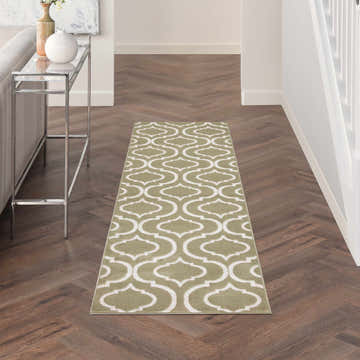 Hallway with Nourison Jubilant Olive rug runner on wood floor. Contemporary style with white geometric pattern.