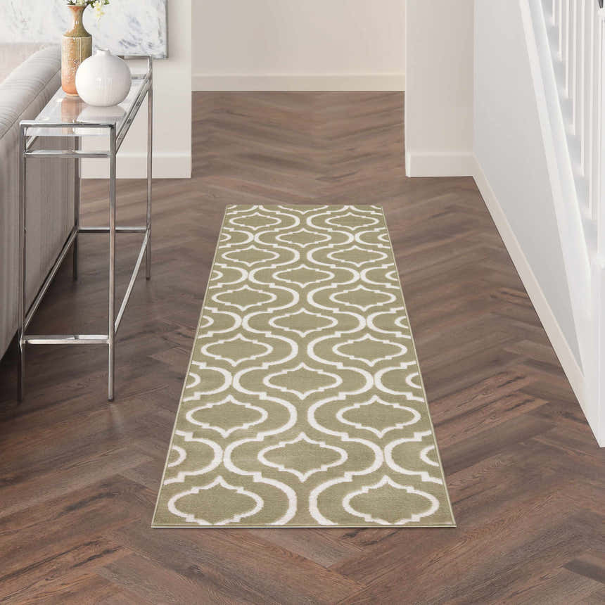 Hallway with Nourison Jubilant Olive rug runner on wood floor. Contemporary style with white geometric pattern.