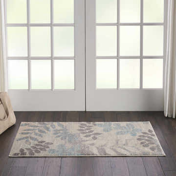 Farmhouse entryway with Nourison Tranquil Ivory/Light Blue rug, dark wood floors, and white french doors.