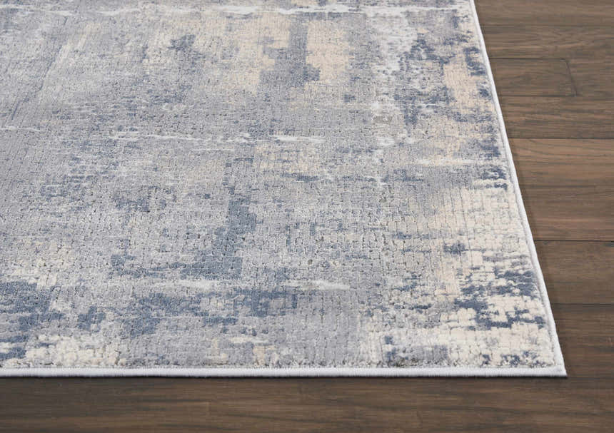 Close-up of the Nourison Rustic Textures Grey Beige rug showing its abstract pattern and textured weave on dark wood floors.