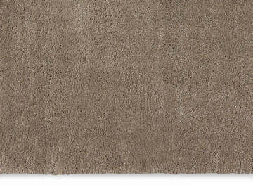 Close-up of the plush texture of a Calvin Klein Brooklyn Silver Gray shag rug.
