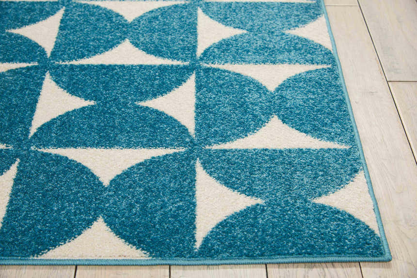 Close-up of the Nourison Harper Blue Colorful Indoor Area Rug, featuring a geometric blue and white pattern.
