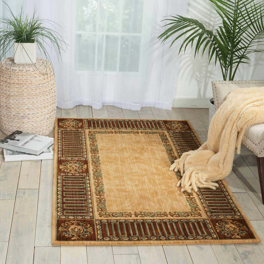 Light-filled room with a beige Nourison Vallencierre vintage rug, wood floors, sheer curtains, and neutral accents.