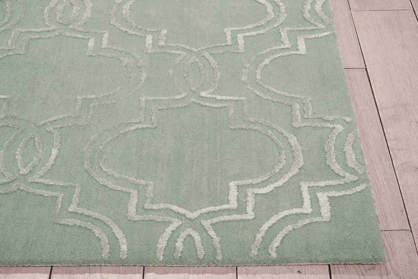Close-up of the Nourison Vita Sage rug, featuring a muted sage color and a charcoal geometric trellis pattern.