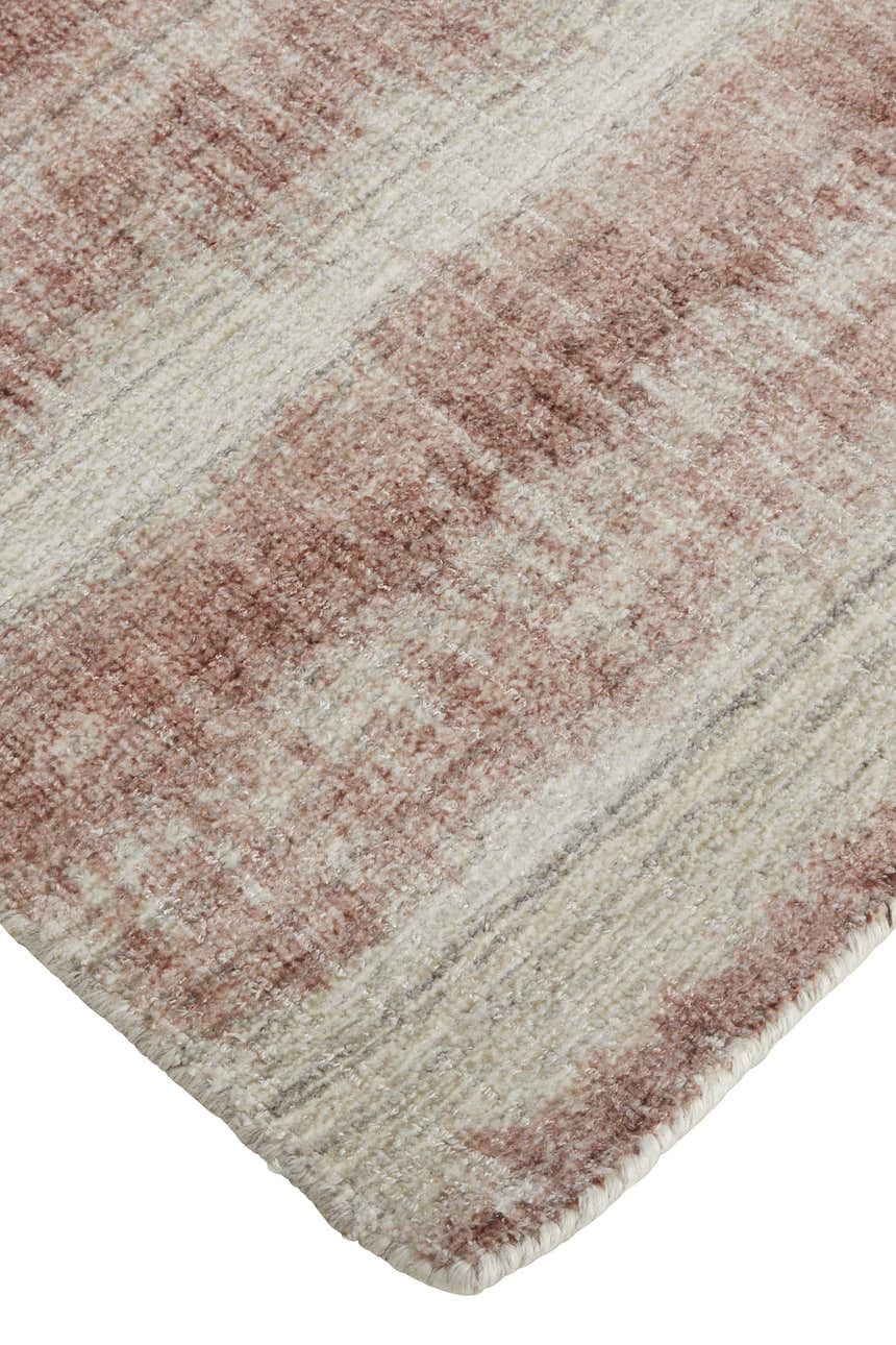 Close-up of the hand-woven Feizy Mackay rug with tan, ivory, and pink stripes. Viscose and wool texture. Corner