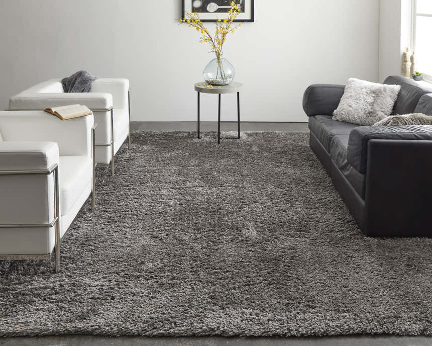 Modern living room with white chairs and a gray sofa featuring the Feizy Darian Modern Solid Gray Area Rug. Roomscene-Rectangle