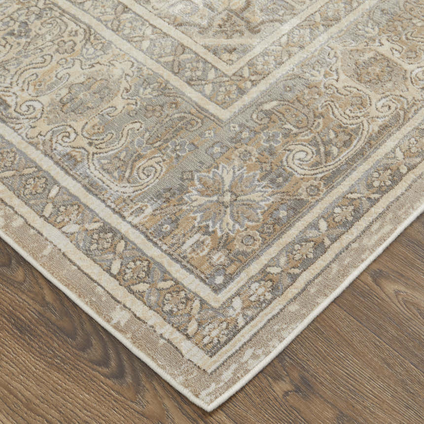 Close-up of Feizy Celene Traditional Medallion rug in tan, brown, and ivory on a wood floor. Vintage style, machine made. Corner