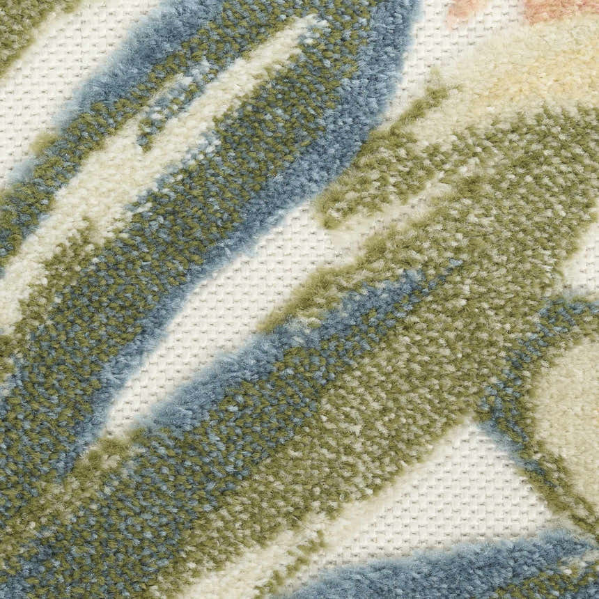 Close-up of the Nourison Aloha Ivory Green Rug, featuring a textured pile with blue and green botanical patterns.