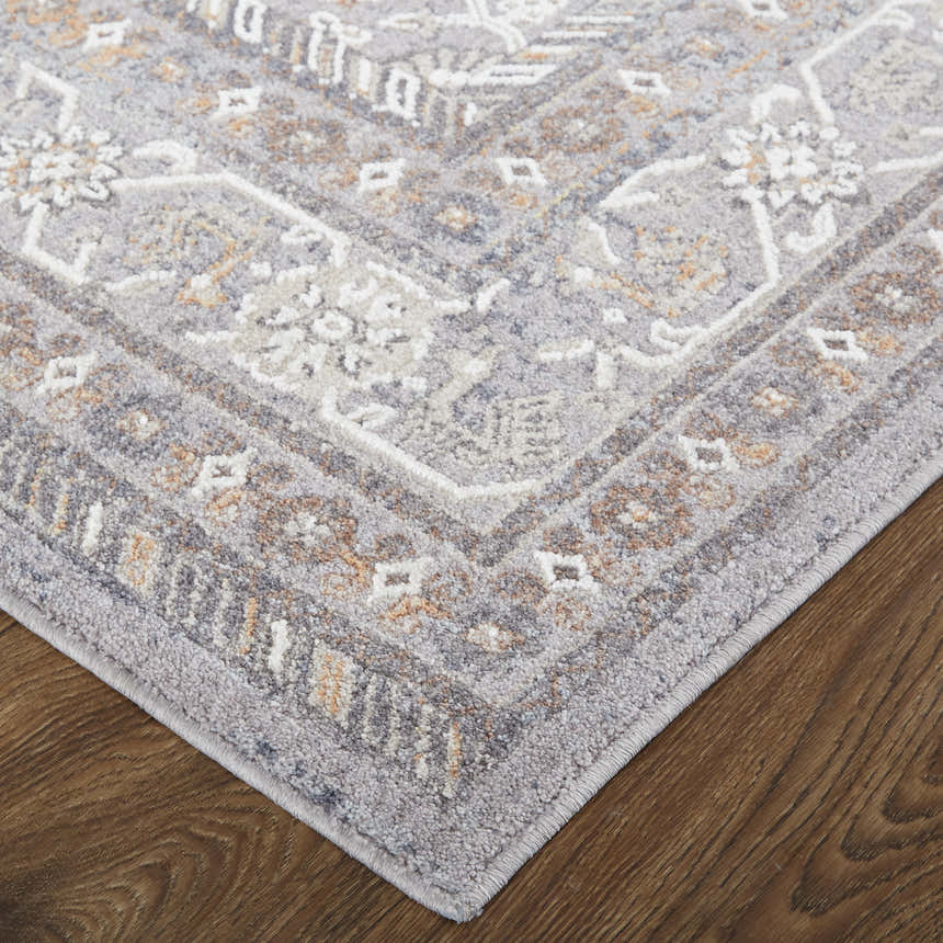 Close up of Feizy Francisco rug, gray, ivory, and orange transitional medallion pattern. Corner