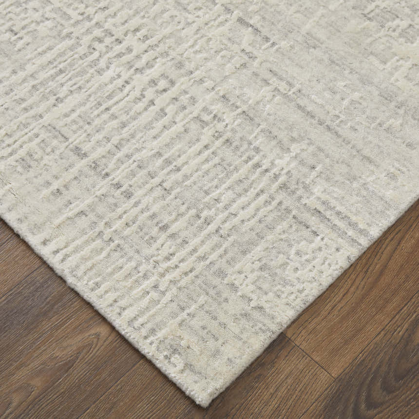 Close-up of the Feizy Eastfield Ivory Area Rug. Modern abstract design with distressed woven texture. Viscose and wool blend. Corner