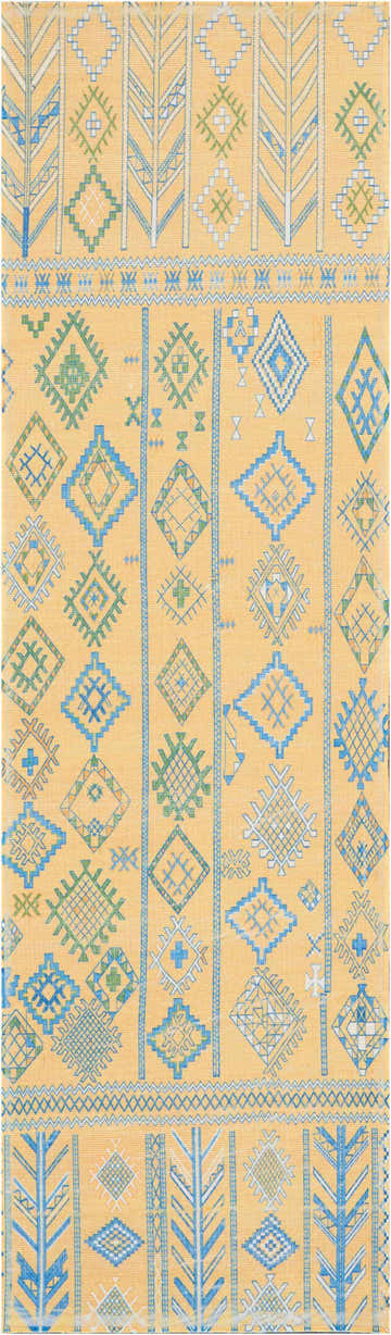 Close-up of Nourison Madera Saffron Tribal rug. Mustard yellow with blue and green geometric diamond and tree pattern.