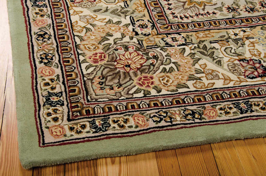 Close-up of the Nourison 2000 Light Green Persian rug. Features a floral pattern, light green border, and wool texture.