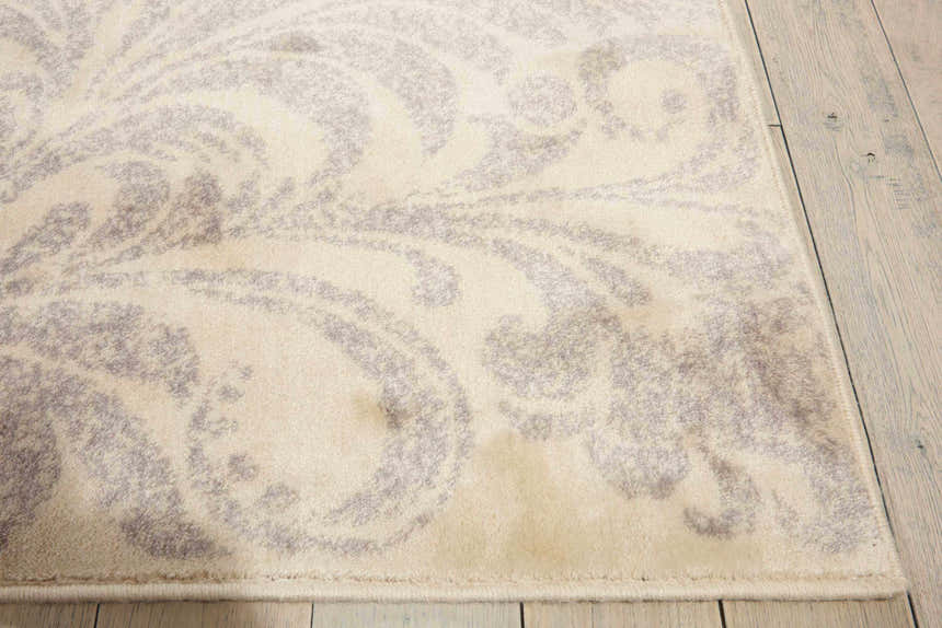 Close up of Nourison Utopia Ivory Floral rug showing chestnut floral pattern and soft texture.