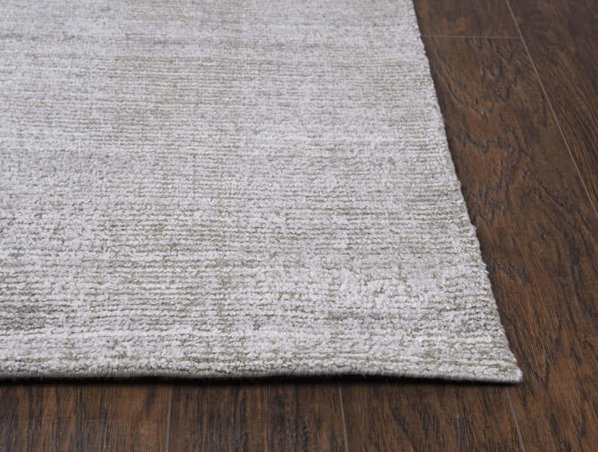 Close up of the Rizzy GH718A area rug. Hand loomed rug in beige, gray, and ivory with a subtle farmhouse design. Corner