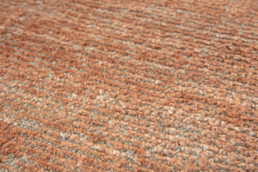 Close-up of the Rizzy GH726A area rug showing its orange color, hand-loomed texture, and wool-tencel blend. Texture