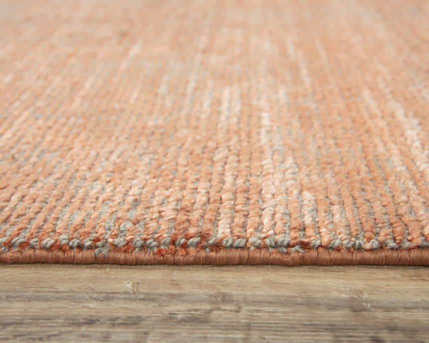 Close-up of the hand-loomed Rizzy GH726A area rug. Orange and gray wool and tencel fibers create a textured, farmhouse style. Pile