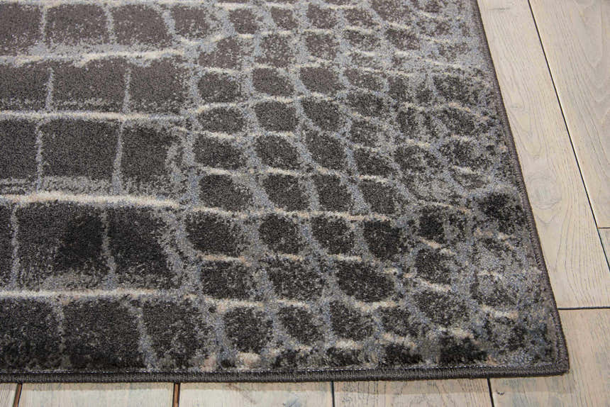 Close-up of the Nourison Maxell Charcoal rug showing its taupe, textured grid pattern and soft polyester material.