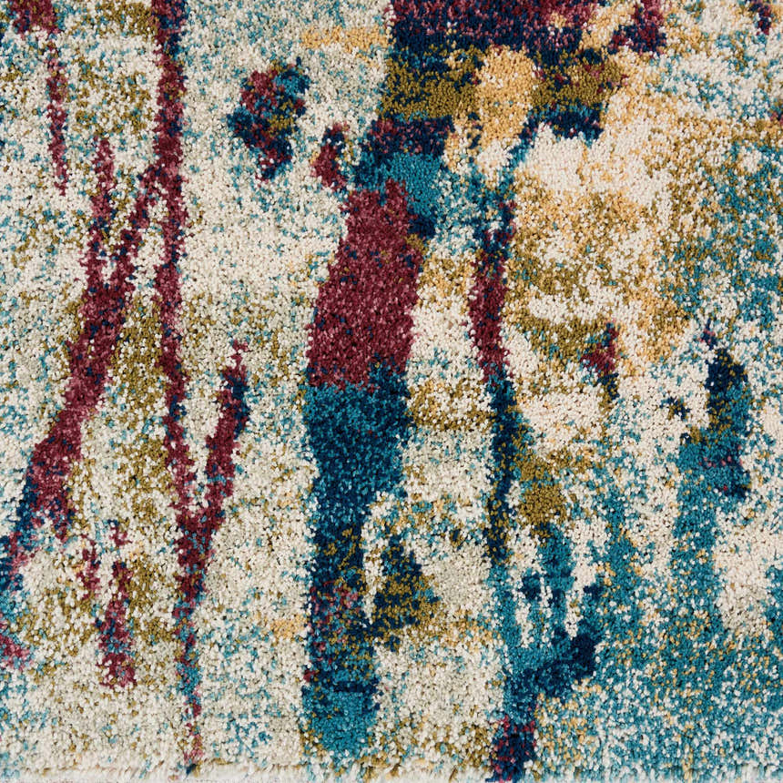 Close-up of Nourison Fusion Cream Multicolor rug. Abstract design with cream, teal, gold, and burgundy hues. Soft texture.