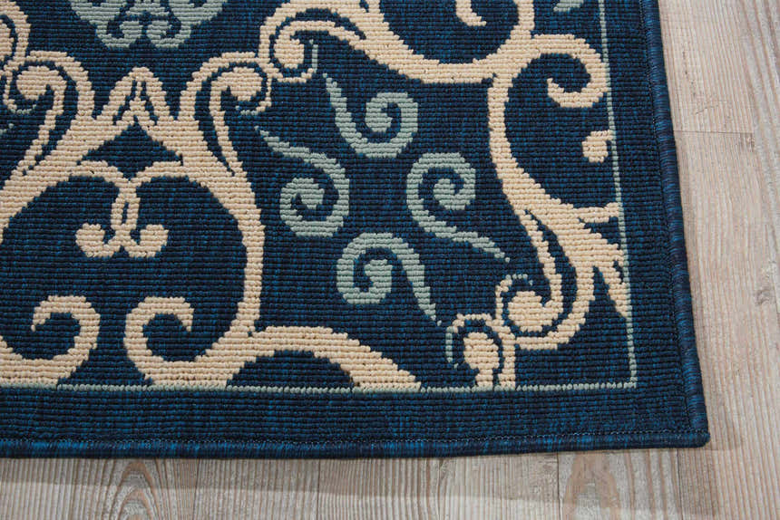 Close-up of Nourison Caribbean Navy rug showing the contemporary floral pattern and textured weave.