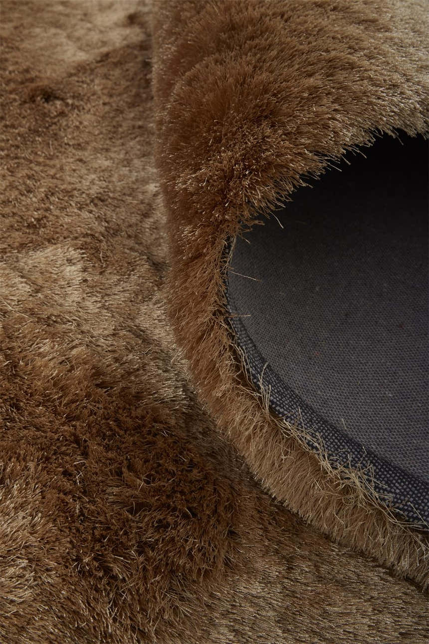 Close-up of the plush, hand-tufted texture and backing of the Feizy Indochine Brown/Gold area rug. Design-Rectangle