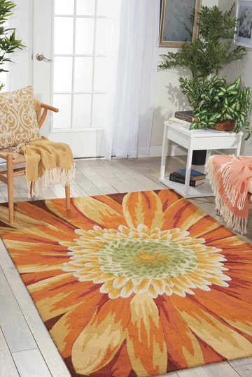 Living room scene with a Nourison Fantasy Multicolor rug featuring a large sunflower design in orange, yellow, and green.
