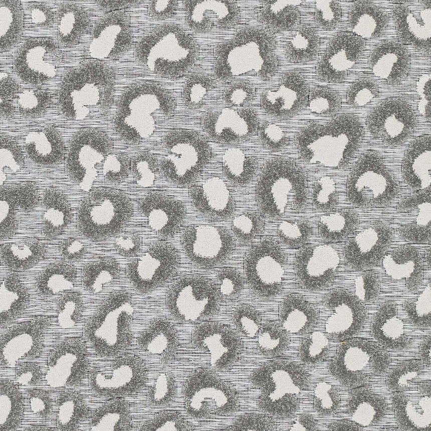 Close-up of the Greensborough Performance Rug showing a gray and white animal print pattern and woven texture. Texture