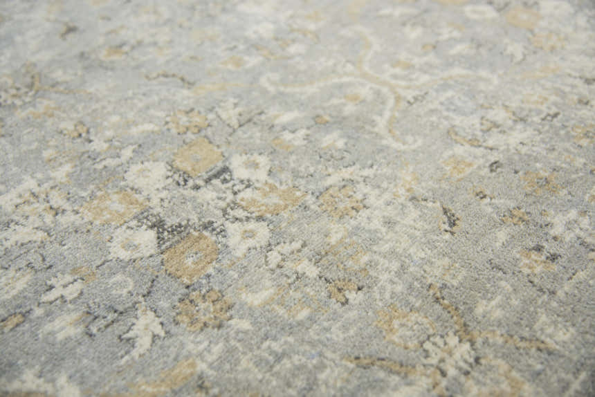 Close-up of Rizzy GS6796 area rug showing beige, gray, and dark red floral pattern and soft texture. Texture