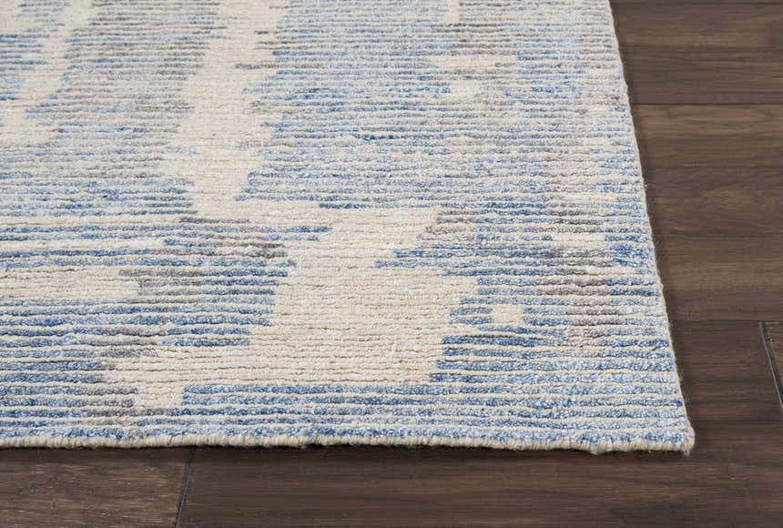 Close up of the Nourison Ellora Blue Rug, a handmade, mid-century modern rug with blue and neutral tones.