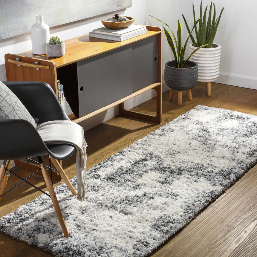 Hallway scene with a Hilotongan Plush Abstract Area Rug in black, cream, and gray. Modern decor with wood accents. Roomscene-Runner