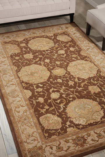 Close-up of Nourison 3000 Brown Indoor Area Rug with floral pattern and dark brown, beige, and light green colors.