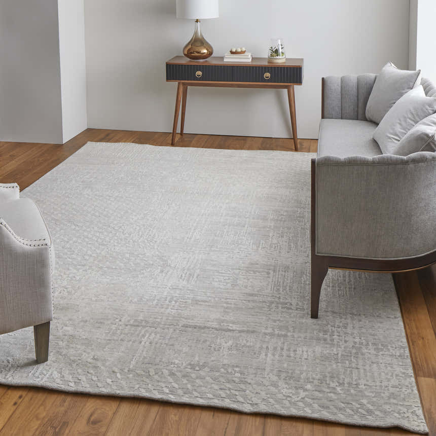 Living room with gray sofa and Feizy Eastfield Ivory rug. Modern, abstract, distressed woven texture rug. Roomscene-Rectangle