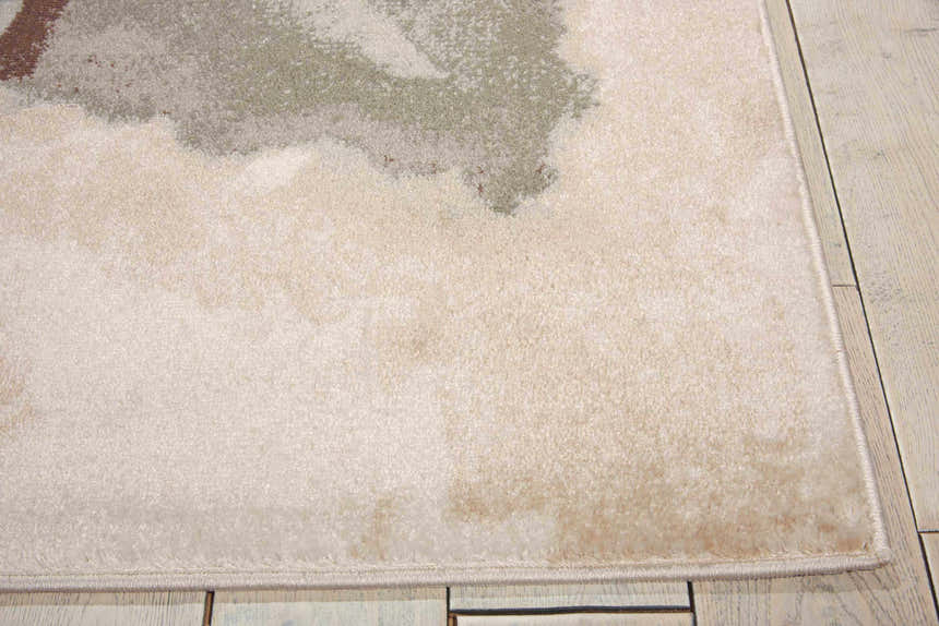 Close-up of the Nourison Euphoria Ivory rug. Chestnut, beige, and sage green abstract design with a soft, plush texture.