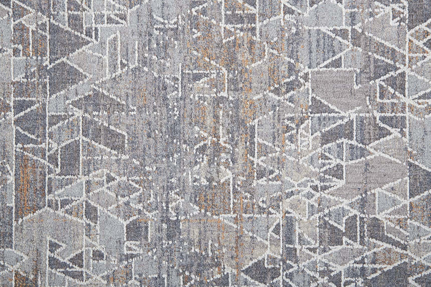 Close-up of the Feizy Francisco rug. Abstract geometric pattern in gray, blue, and orange hues. Soft, textured surface. Texture