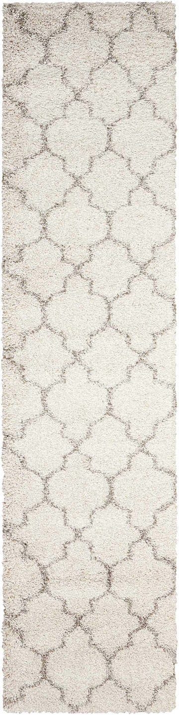 Cream shag rug close-up. Nourison Amore rug with geometric trellis pattern and soft, plush texture.