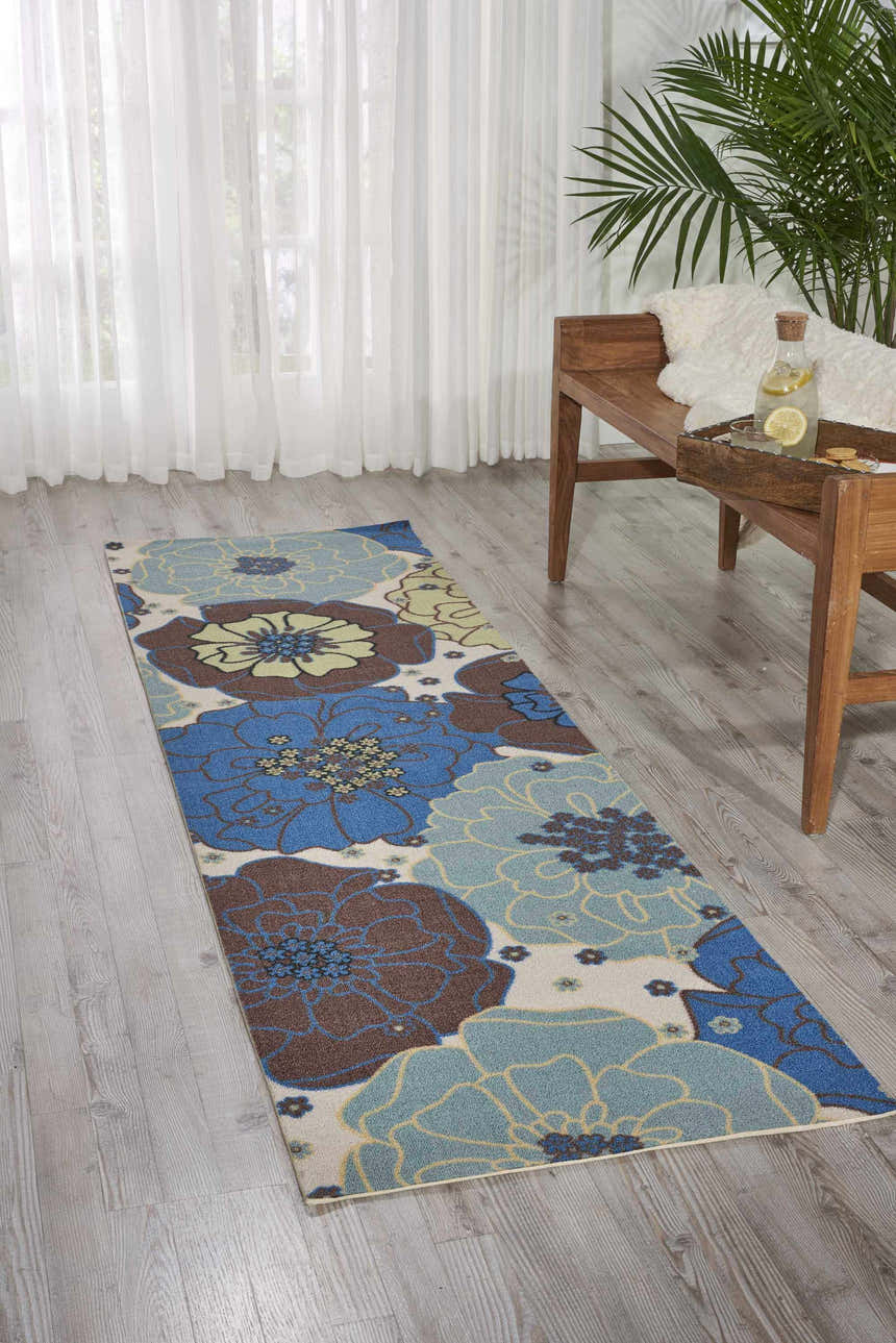 Light blue floral runner rug in entryway with wood bench and sheer curtains. Nourison Home & Garden rug.