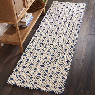 Hallway scene with Nourison Deco Mod Navy Ivory runner rug on dark wood floor.