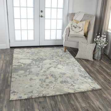 Entryway with Rizzy IMP104 area rug in beige, gray, and ivory. Contemporary rug styled with gray chair and white french doors. Roomscene-Rectangle