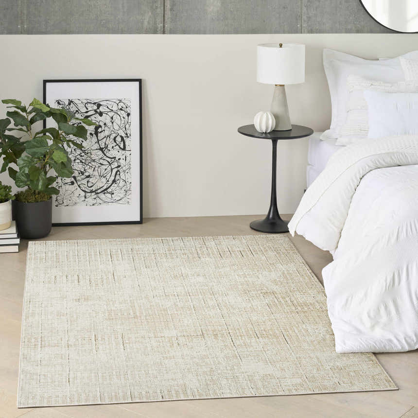 Modern bedroom scene with DKNY Grand Street Ivory Beige rug, white bedding, black side table and abstract art.