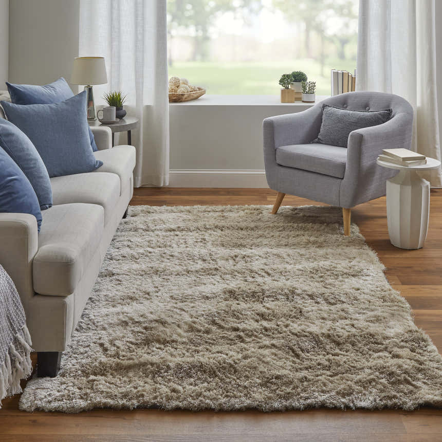Living room scene with Feizy Indochine Modern Solid Tan/Taupe Area Rug, sofa, chair, and natural light. Roomscene-Rectangle