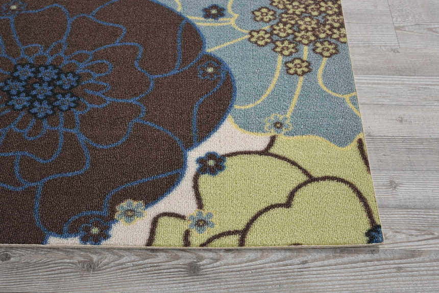 Close-up of Nourison Home & Garden Light Blue rug featuring a floral pattern in brown, blue, and green on a light blue background.