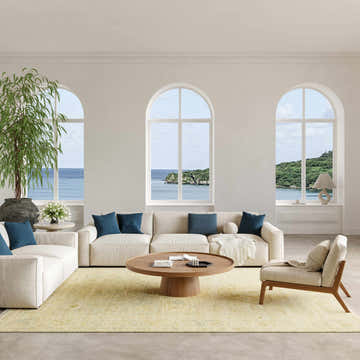 Coastal living room with cream sofas and Nourison Odessa Green Vintage rug.