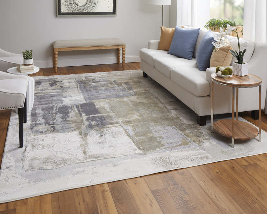 Living room scene with a Feizy Clio Brown/Gray Area Rug, white sofa, and wood floors. Roomscene-Rectangle