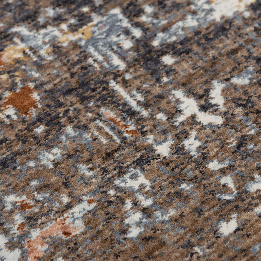 Close-up of the Rizzy JAS738 area rug. Abstract design in dark red, gray, brown, and white. Machine woven texture. Texture