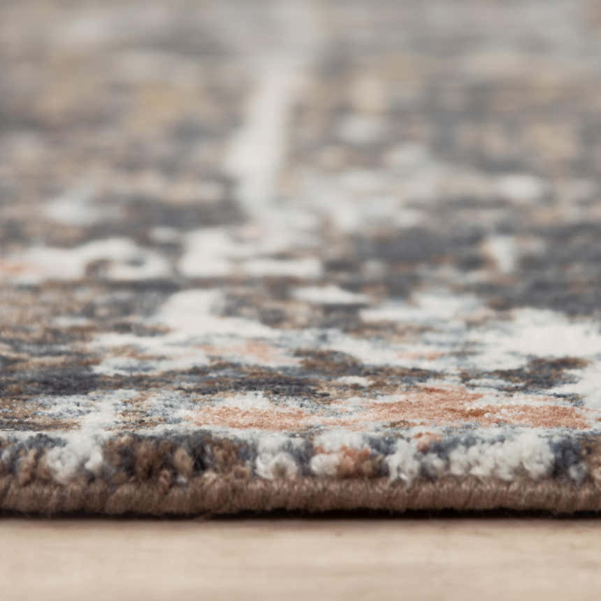 Close-up of Rizzy JAS738 area rug showing abstract pattern, dark red, and gray recycled polyester texture. Pile