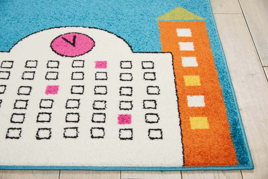 Close-up of Nourison Miles Blue Kids Rug featuring a building and calendar design with pink, orange, and white accents.