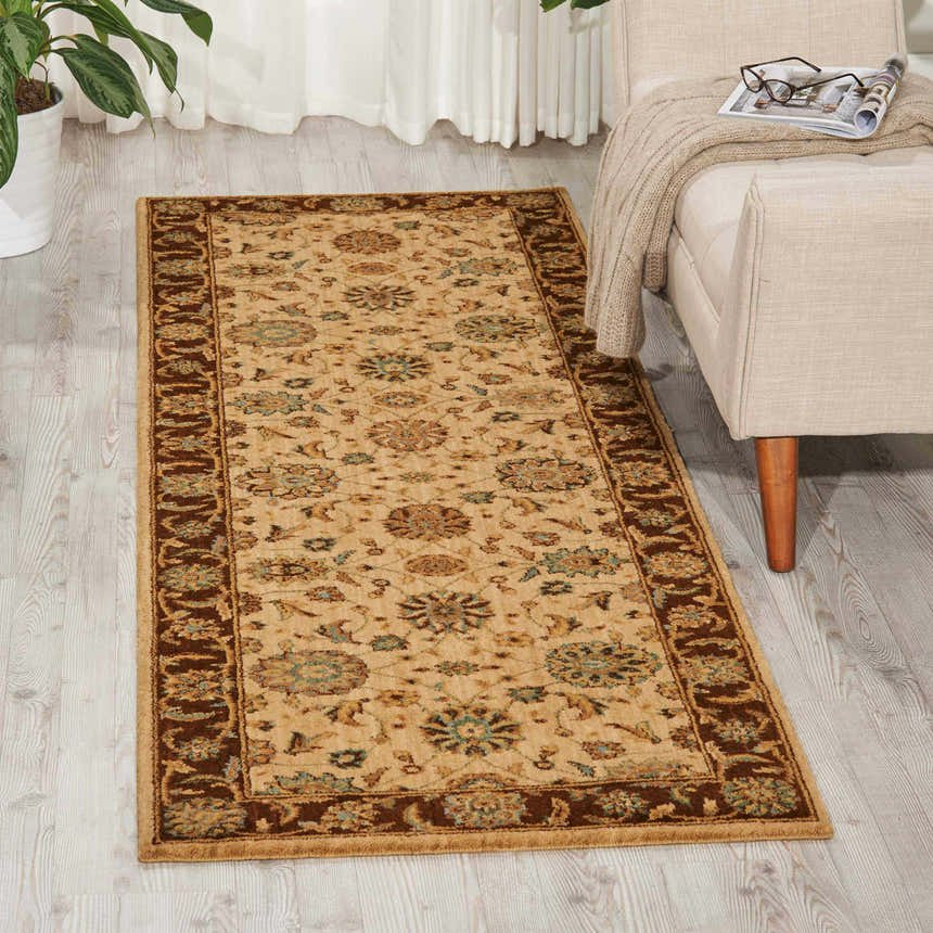Living room scene with a Nourison Living Treasures Beige rug, chair, and plant.