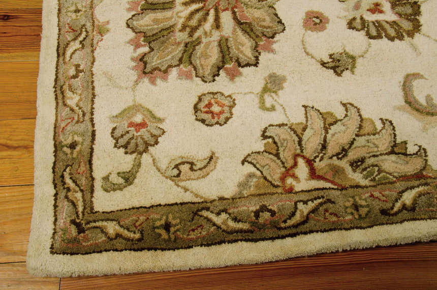 Close up of the handmade Nourison Jaipur Ivory Persian rug with chestnut, wool, and cotton details.