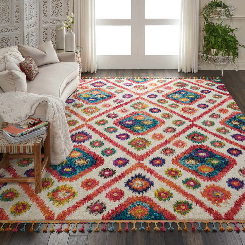 Living room with a Nourison Nomad Ivory Pink Tribal rug, sofa, and bright, natural light.