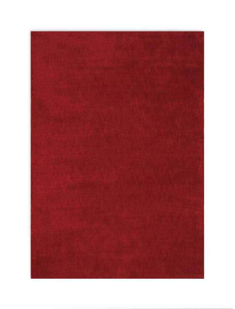 Close-up of the Calvin Klein L.A. Burgundy rug. Solid, deep red color with a subtle texture. Mid-century modern style.