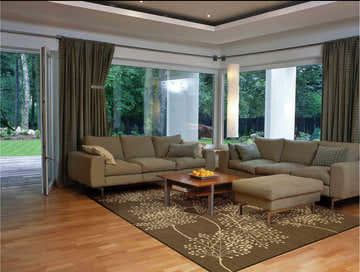 Living room with brown sofas and Nourison Capri Chocolate Floral rug on wood floor.